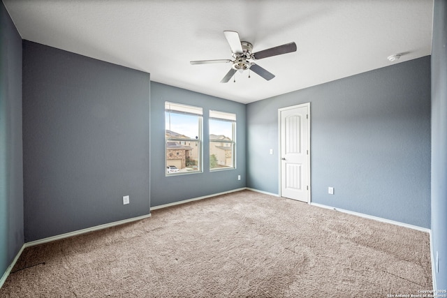 carpeted empty room featuring ceiling fan