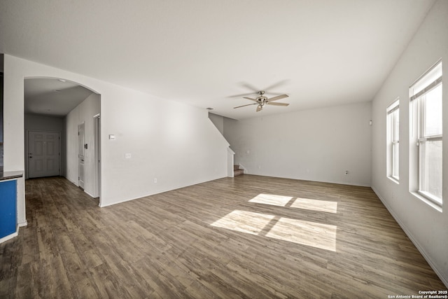 unfurnished living room featuring hardwood / wood-style floors and ceiling fan