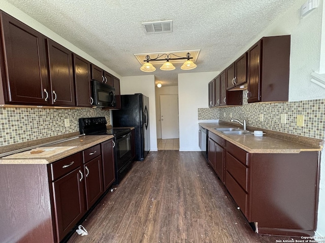 kitchen with dark hardwood / wood-style flooring, sink, dark brown cabinetry, and black appliances