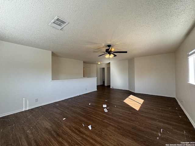 spare room with ceiling fan, dark hardwood / wood-style flooring, and a textured ceiling