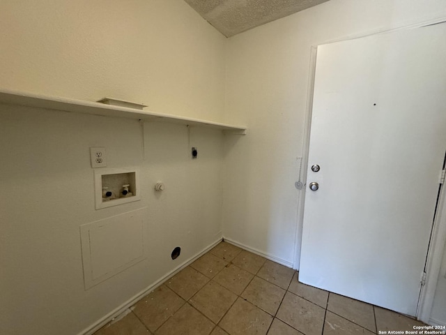 laundry room with hookup for an electric dryer, hookup for a washing machine, a textured ceiling, and hookup for a gas dryer