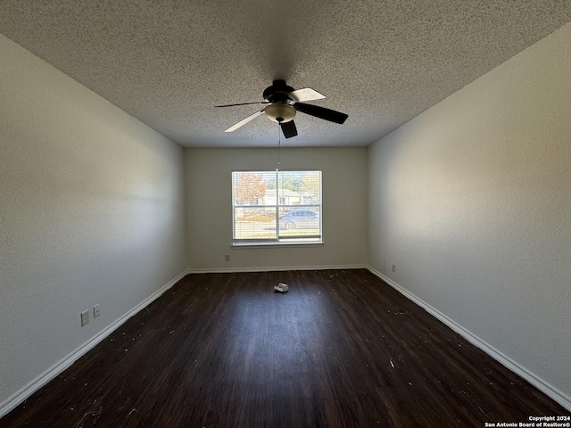 empty room with dark hardwood / wood-style floors, ceiling fan, and a textured ceiling