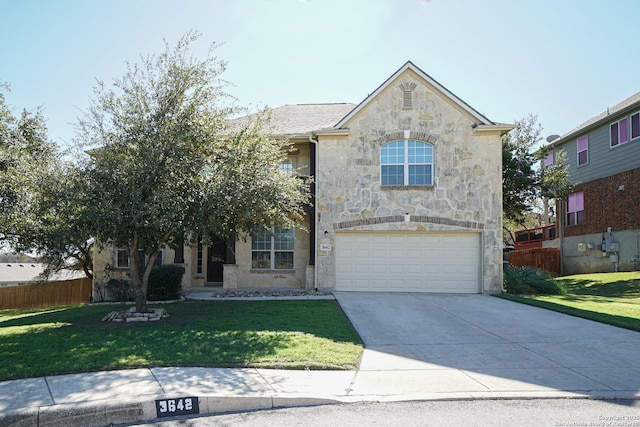 view of front of property with a front yard and a garage