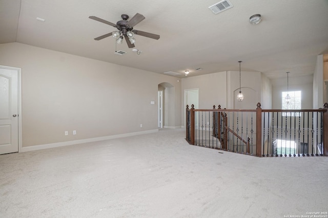 unfurnished room featuring carpet flooring, ceiling fan with notable chandelier, and vaulted ceiling