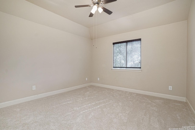 carpeted empty room featuring ceiling fan and lofted ceiling