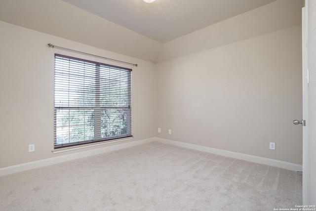 unfurnished room with a wealth of natural light, light colored carpet, and lofted ceiling