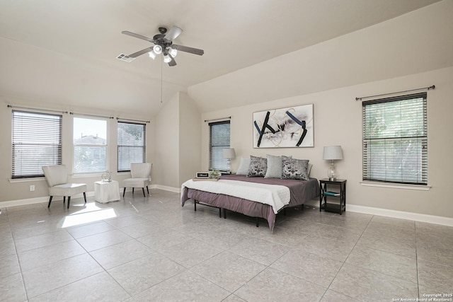 bedroom with multiple windows, light tile patterned floors, ceiling fan, and lofted ceiling