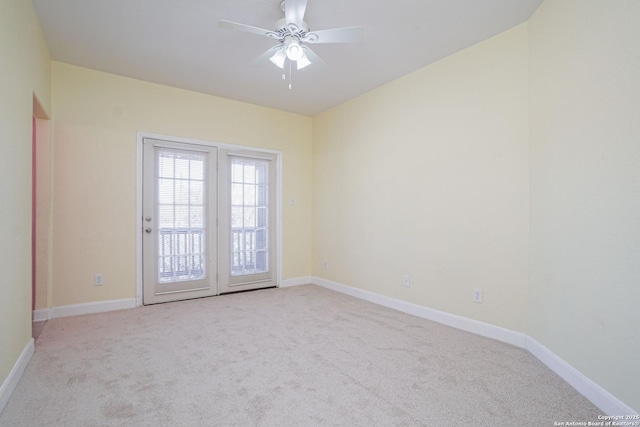 spare room featuring ceiling fan and light colored carpet