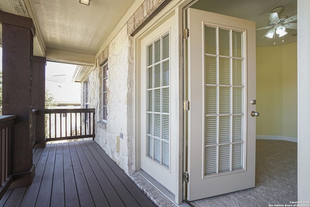 wooden deck with a porch and ceiling fan