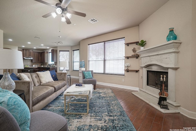 living room with ceiling fan and dark hardwood / wood-style flooring