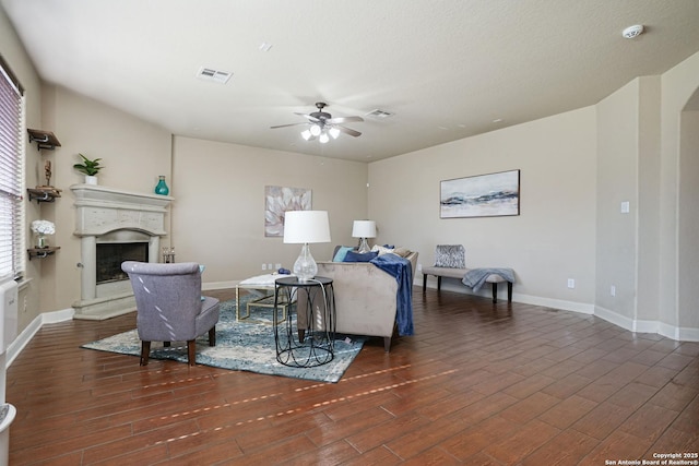 living room with dark hardwood / wood-style floors and ceiling fan