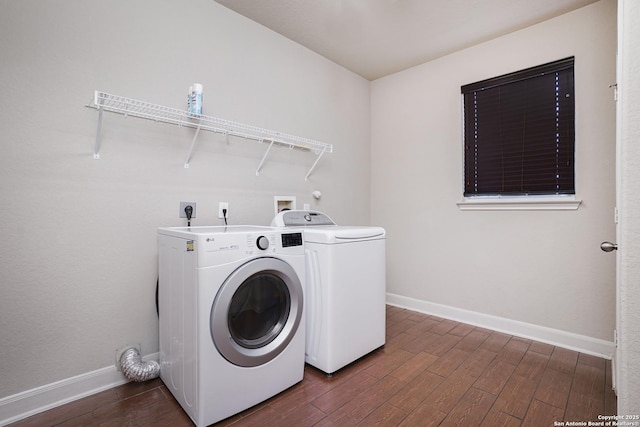 clothes washing area featuring washer and dryer and dark hardwood / wood-style floors