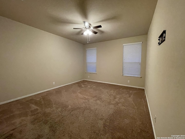 unfurnished room with carpet and ceiling fan