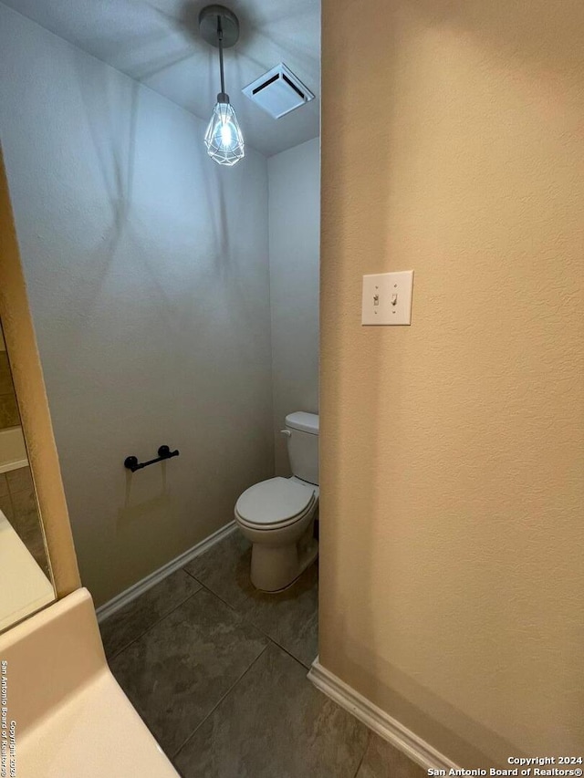 bathroom featuring tile patterned flooring and toilet