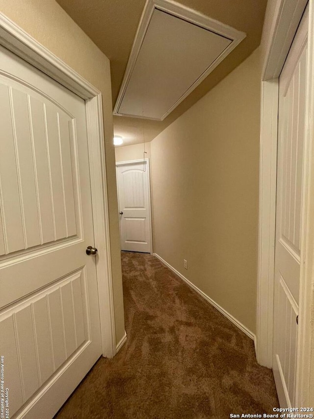 corridor with dark colored carpet