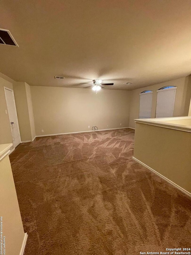 spare room featuring carpet and ceiling fan