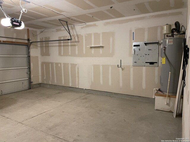 garage with a garage door opener and water heater