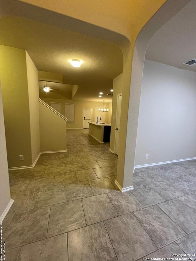 hall with a textured ceiling and sink