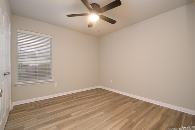 empty room featuring ceiling fan and hardwood / wood-style flooring