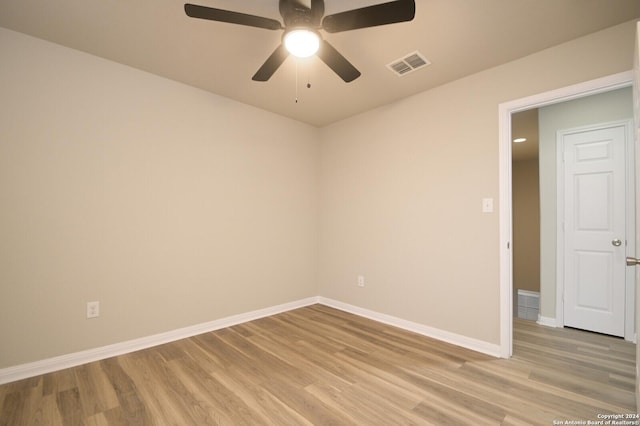 empty room featuring ceiling fan and light hardwood / wood-style floors