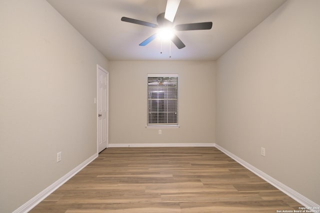 unfurnished room featuring ceiling fan and hardwood / wood-style floors