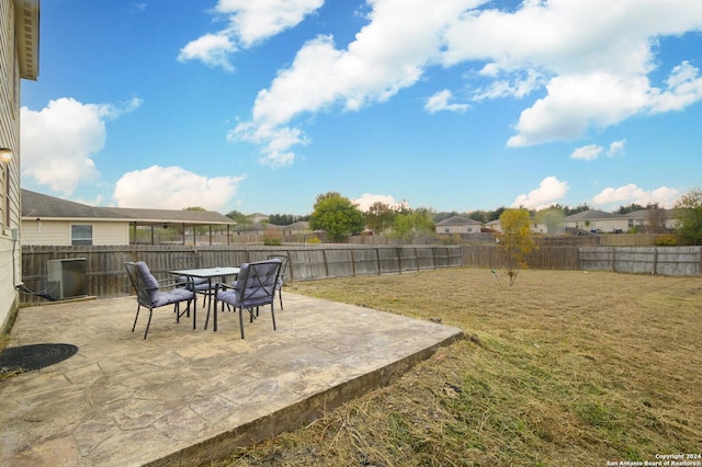 view of yard featuring a patio area and central air condition unit