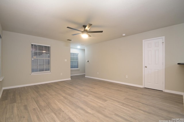 unfurnished room with ceiling fan and light hardwood / wood-style flooring