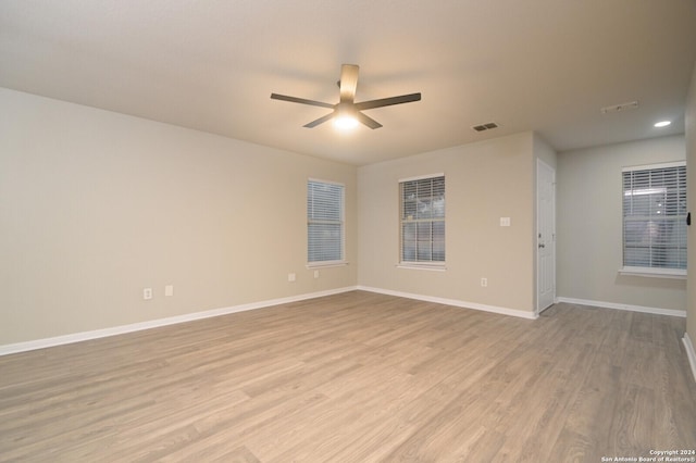 spare room with ceiling fan and light hardwood / wood-style flooring