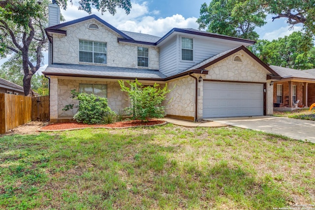 front of property featuring a front yard and a garage