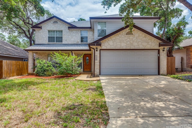 front of property with a front yard and a garage