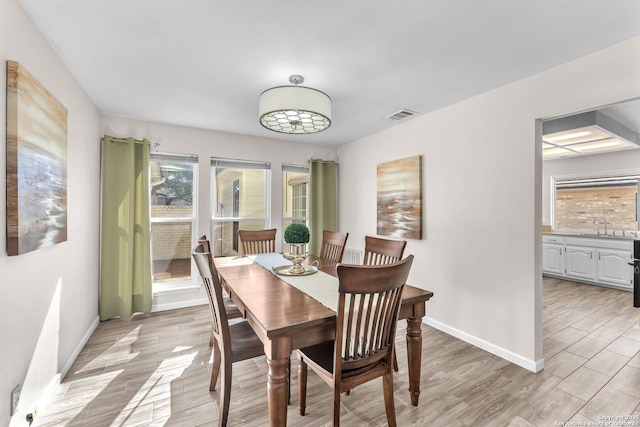 dining space featuring light hardwood / wood-style floors and sink