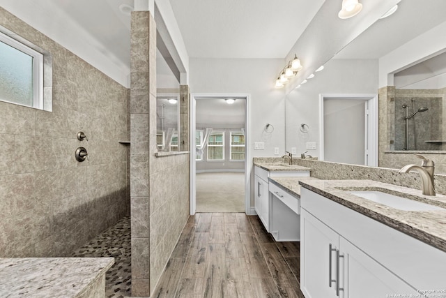 bathroom with vanity and tiled shower