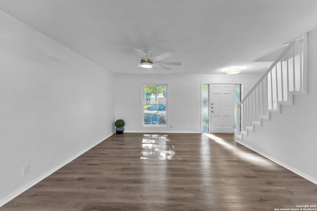 entryway with ceiling fan and dark wood-type flooring