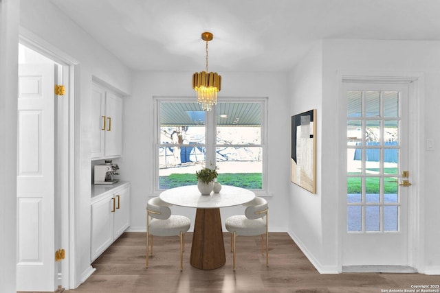 dining area with dark hardwood / wood-style flooring and a chandelier