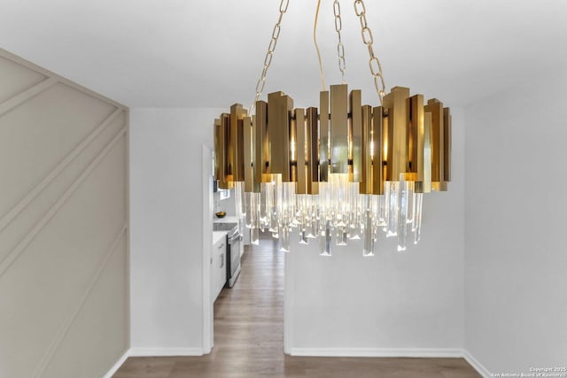 interior space with hardwood / wood-style flooring, an inviting chandelier, and stainless steel electric range oven