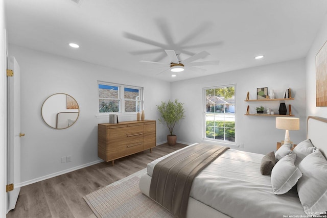 bedroom featuring ceiling fan and light hardwood / wood-style flooring