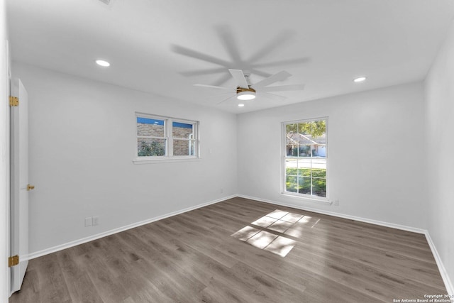 spare room with ceiling fan and hardwood / wood-style flooring