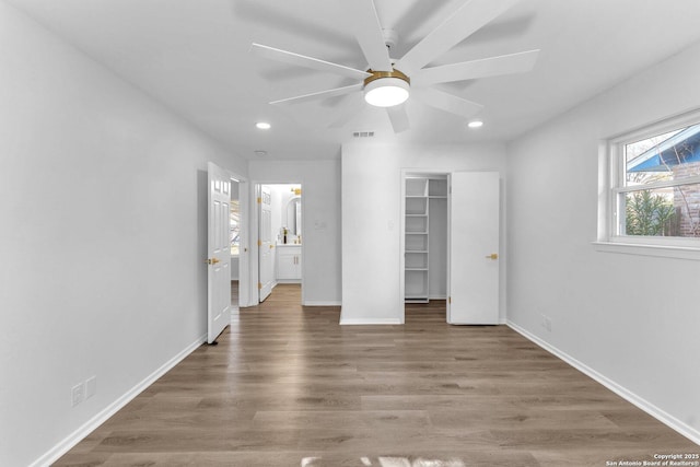 interior space with ceiling fan and wood-type flooring