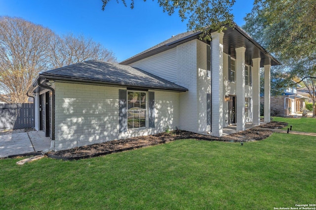 view of side of home with a yard