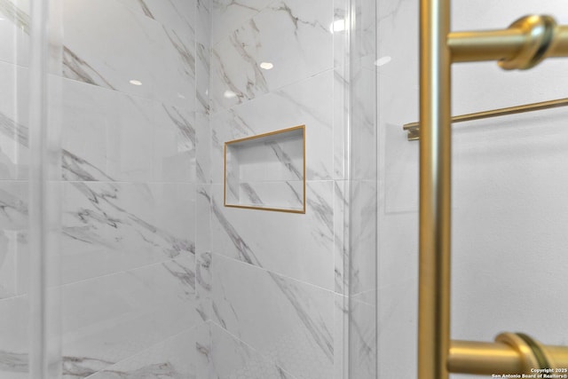 bathroom with a tile shower