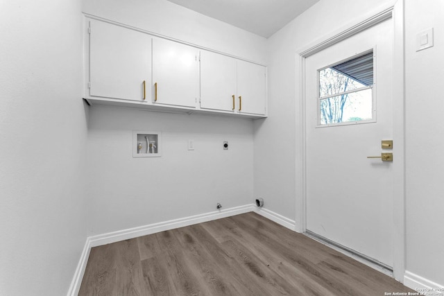 washroom with washer hookup, electric dryer hookup, light hardwood / wood-style floors, and cabinets