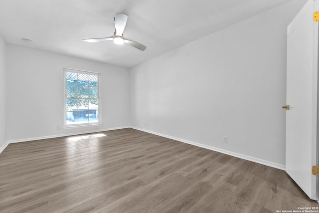 empty room featuring hardwood / wood-style flooring and ceiling fan