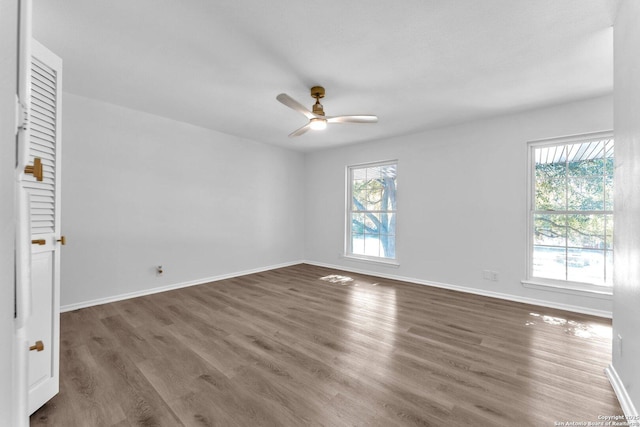 spare room with dark hardwood / wood-style floors and ceiling fan