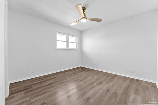 empty room featuring hardwood / wood-style flooring and ceiling fan