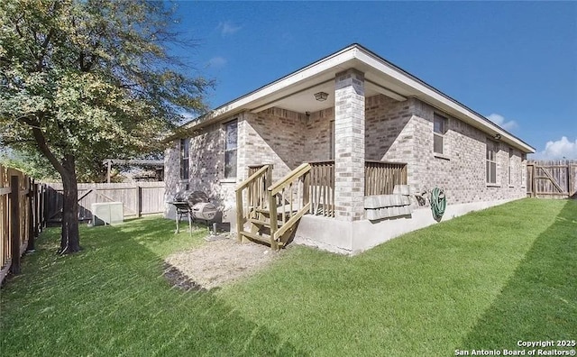 rear view of house with a yard