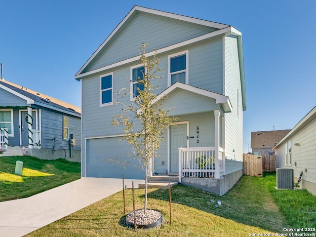 front of property with central air condition unit, a front lawn, and a garage