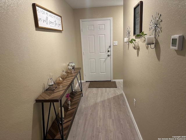 doorway to outside with wood-type flooring