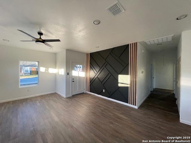 spare room with ceiling fan and dark hardwood / wood-style floors