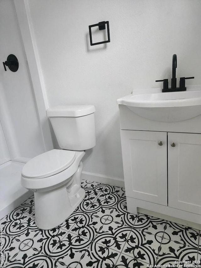 bathroom with tile patterned floors, vanity, and toilet