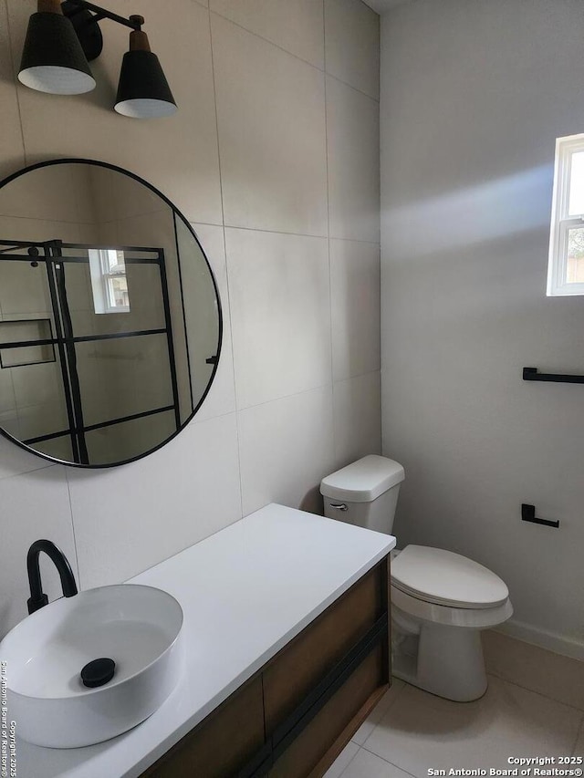 bathroom featuring tile patterned flooring, vanity, and toilet